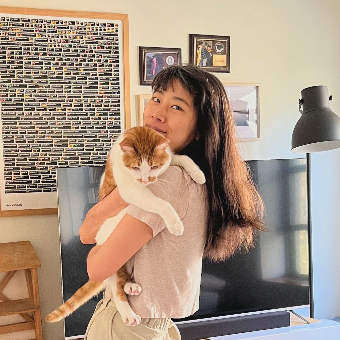 Photograph of Yoko Sakao Ohama holding her orange-and-white cat