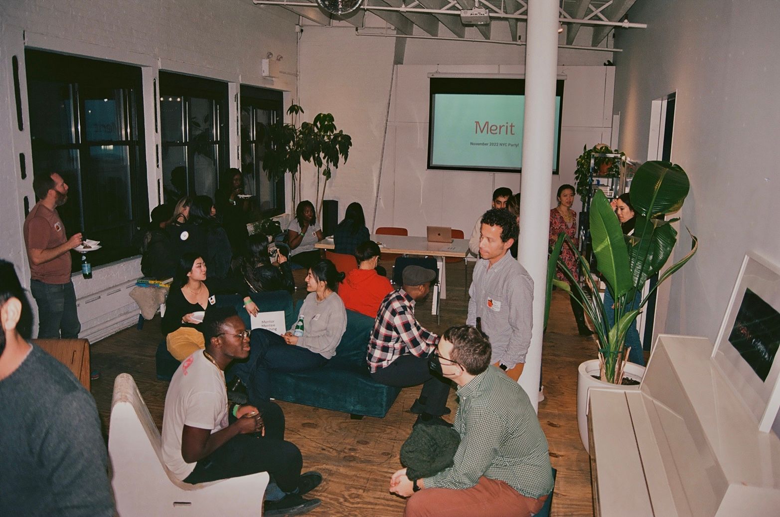 A candid photograph of groups of people talking in an event space.