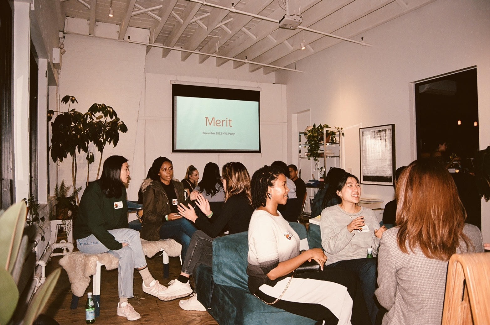 A candid photograph of groups of people talking in an event space.